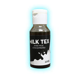 A 2 oz bottle of Milk Tex fake milk concentrate for magic tricks, with a black and white label.