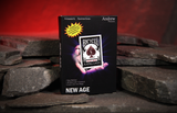 A black box for the New Age Bicycle gimmick, standing upright on a stack of dark slate stones against a warm red cave background.