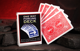 A Bicycle card deck labeled 'ONE WAY FORCING DECK' stands beside five fanned playing cards showing red Bicycle back designs, set on dark stones against a glowing red cave background.