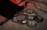 10 Replica Half Dollar palming coins for magic on a stone floor with a glowing red cave background.