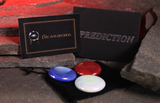 A prediction card and envelope with three coloured runes on a black velvet pouch, styled on a dark stone glowing red background. One card reads 'FATE HAS DECIDED.