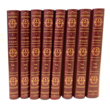A set of eight red book dust jackets with gold embossed designs, labeled 'A Course in Magic' for volumes 1 through 8.
