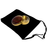 Okito box magic trick on a black drawstring bag with a white background with two palming coins.
